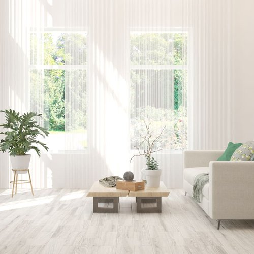 white couch in a bright white living room with white hardwood floor from Traditional Floors in Milan, IL