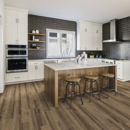 brown island kitchen table with white countertop and brown vinyl floor from Traditional Floors in Milan, IL