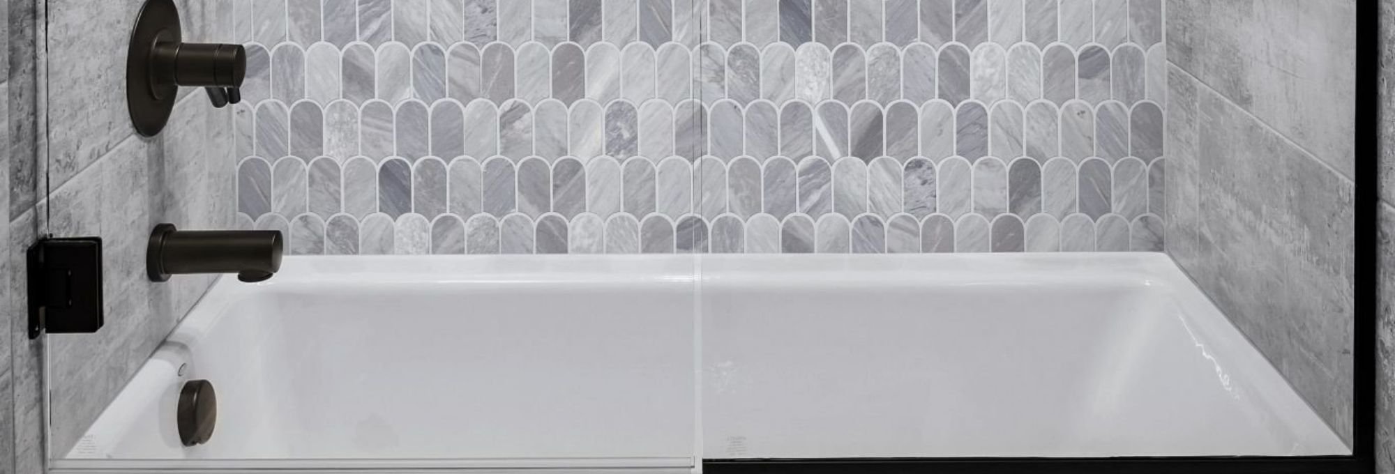 white bathtub with black accessories and gray wall tiles from Traditional Floors in Milan, IL