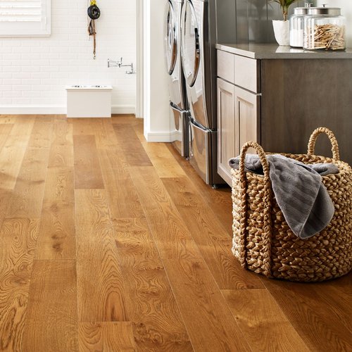 Basket laundry on a brown hardwood from Traditional Floors in Milan